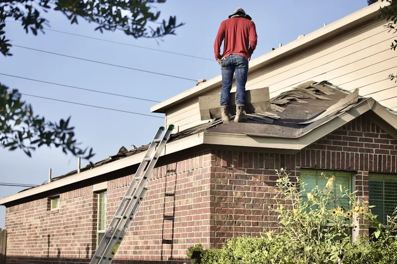 Professional roofer working on a residential roof in Ho Ho Kus
